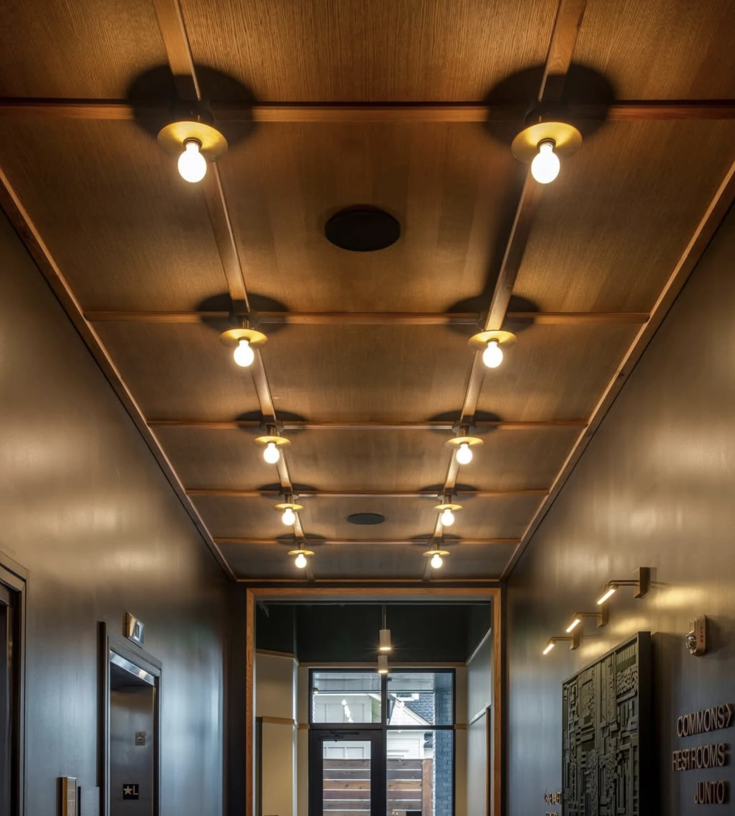 Custom corridor lighting installation coordinated with architectural and hospitality design requirements.