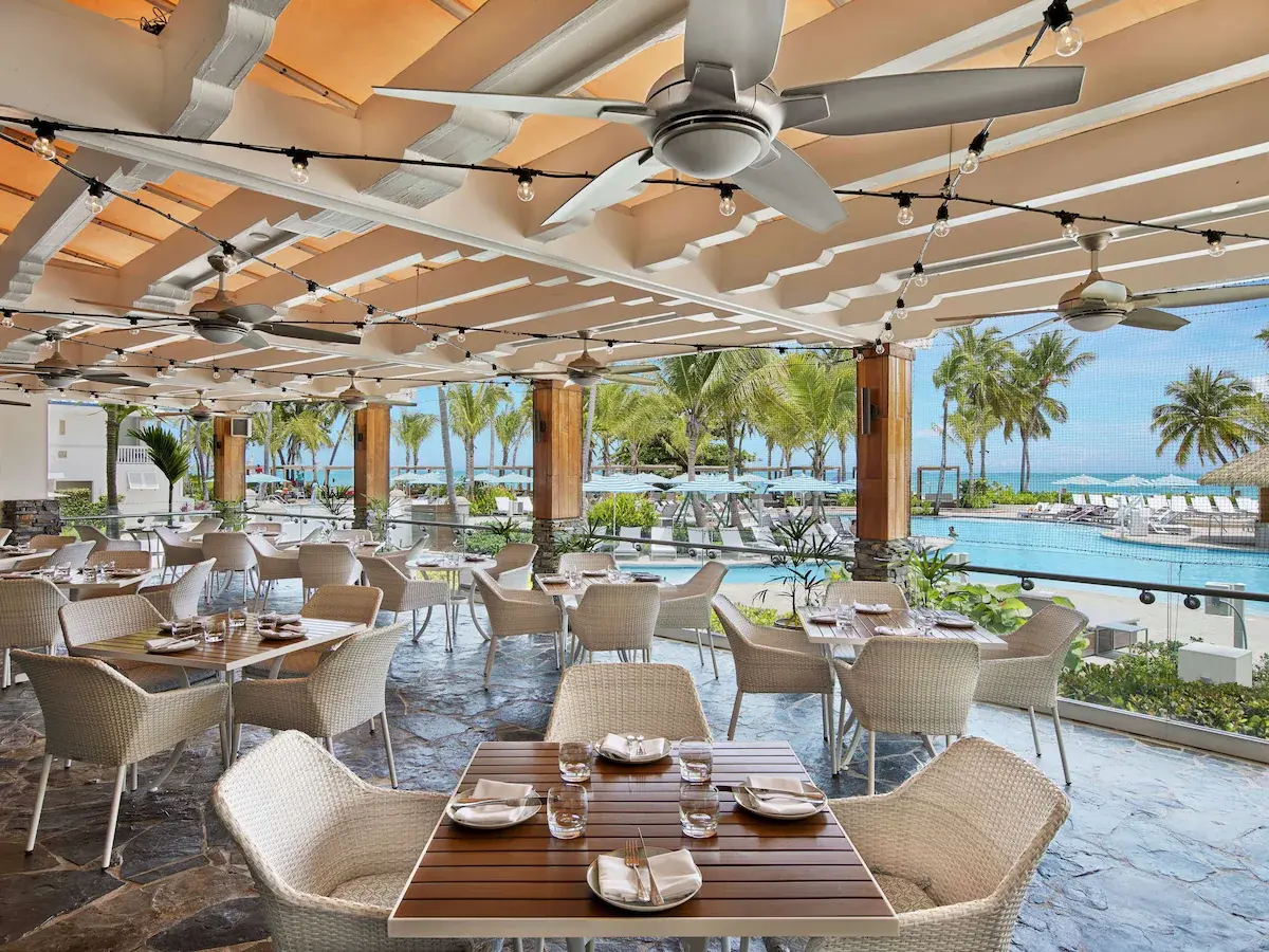Covered outdoor dining area overlooking the resort grounds at Fairmont El San Juan Hotel.